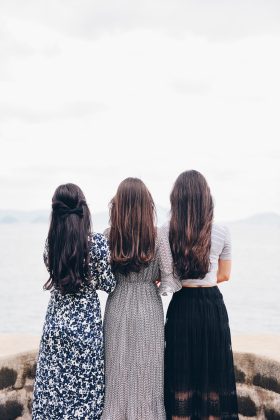 Three women looking at the ocean